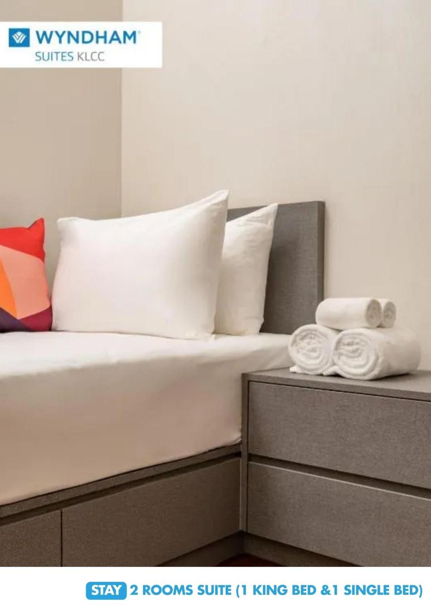 Wyndham Suites Klcc 吉隆坡 外观 照片 A bed with a duvet cover